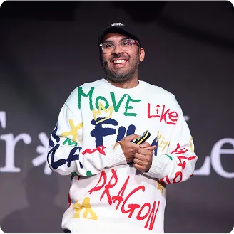 Manon Dave smiling in a bold top